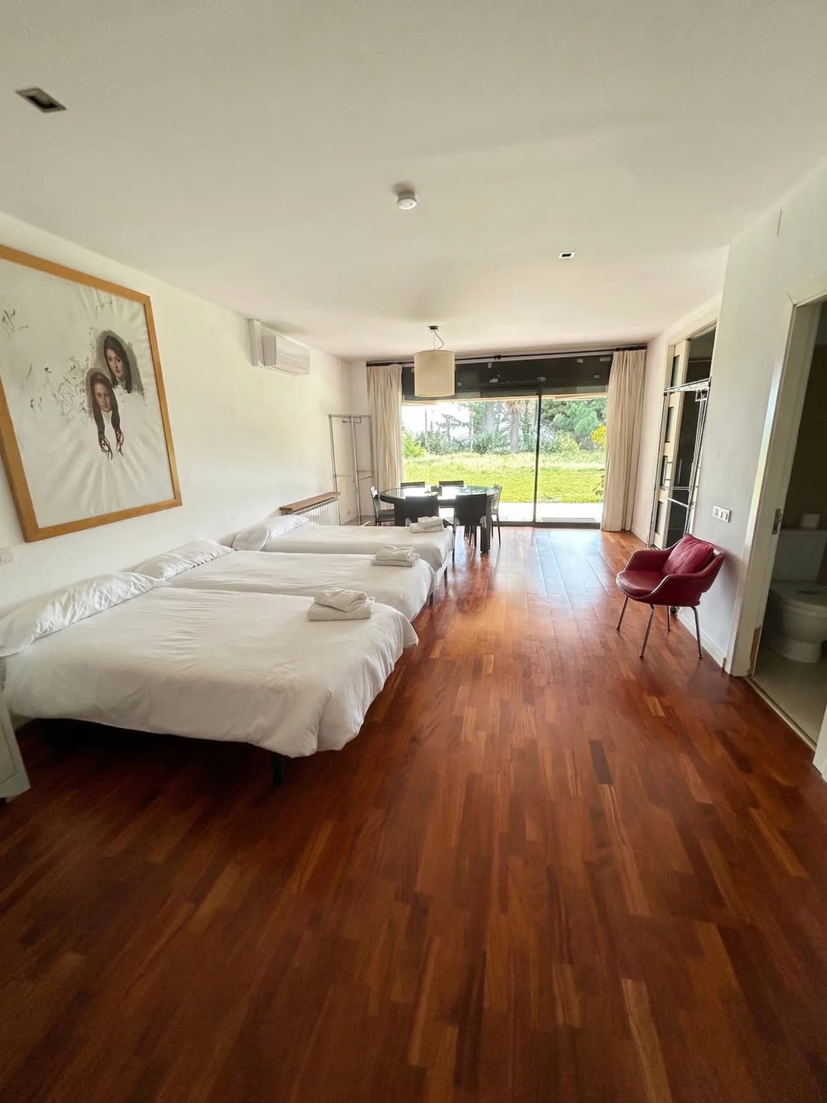 Spacious triple bedroom with art