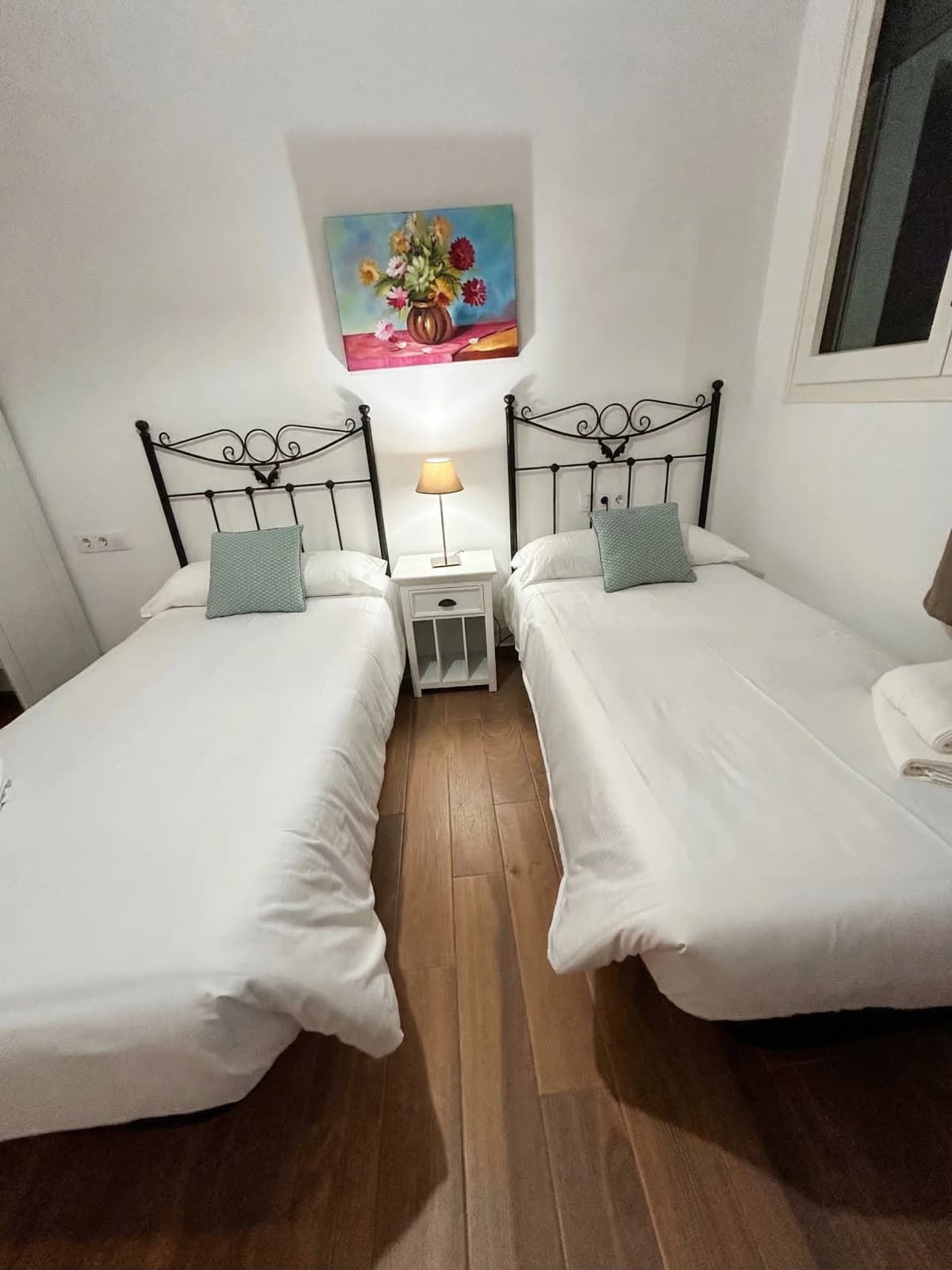 Twin beds with wrought-iron headboards