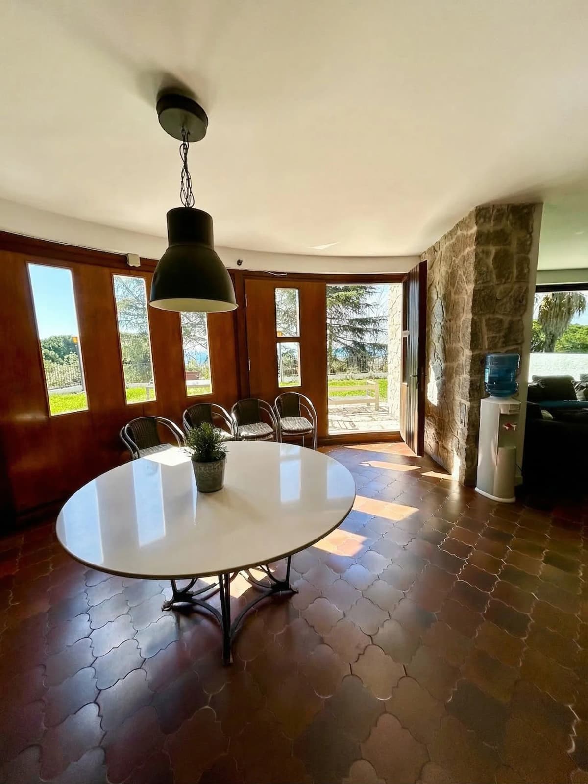 Dining area with stone wall and round table