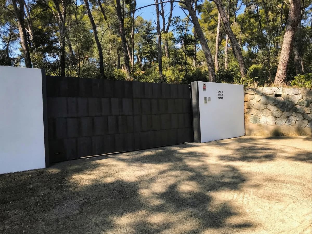 Property gate with pine forest
