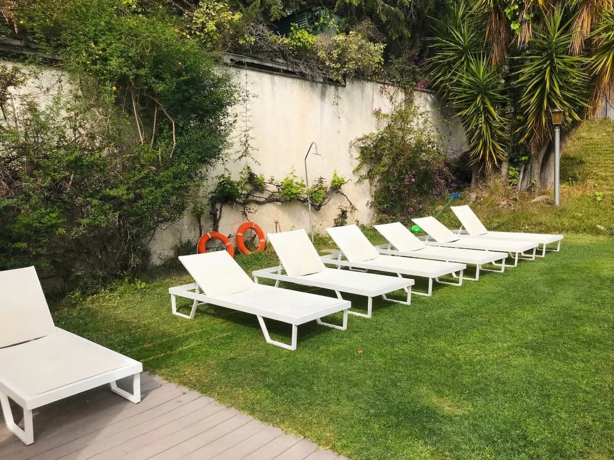 White sun loungers by the pool