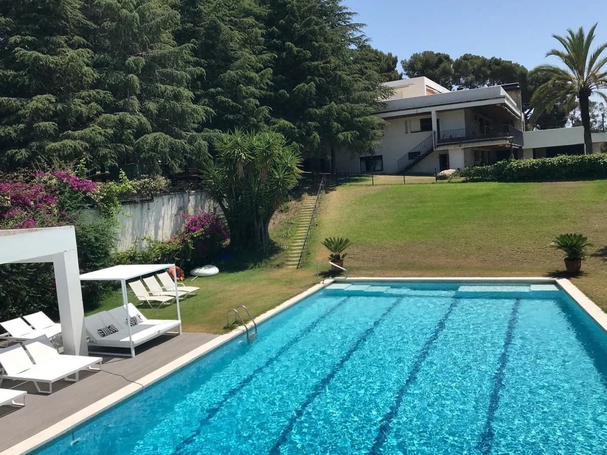Swimming pool with bougainvillea and villa view